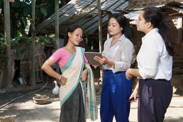 Young Businesswomen interacting with an agricultural worker in a farm